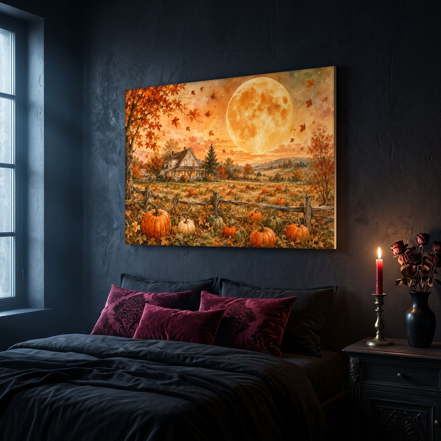 Homestead Moonrise canvas hanging on a dark navy wall in a moody bedroom, above a bed with burgundy velvet pillows and charcoal bedding, beside a lit red taper candle in a brass holder and a black vase of dark roses on the nightstand.