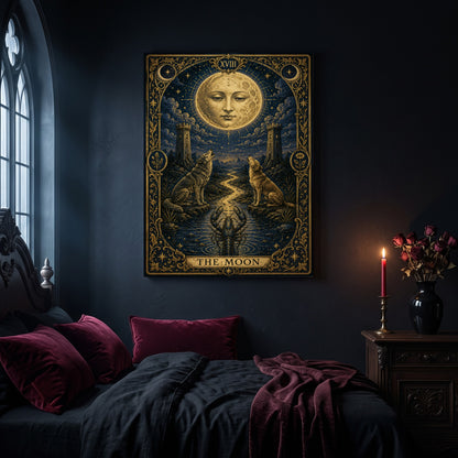 La Lune tarot canvas hanging on a dark navy wall in a gothic bedroom, above a bed with burgundy velvet pillows and charcoal bedding, beside an arched leaded window and a wooden nightstand holding a lit red taper candle in a brass holder and a black vase of dried roses.
