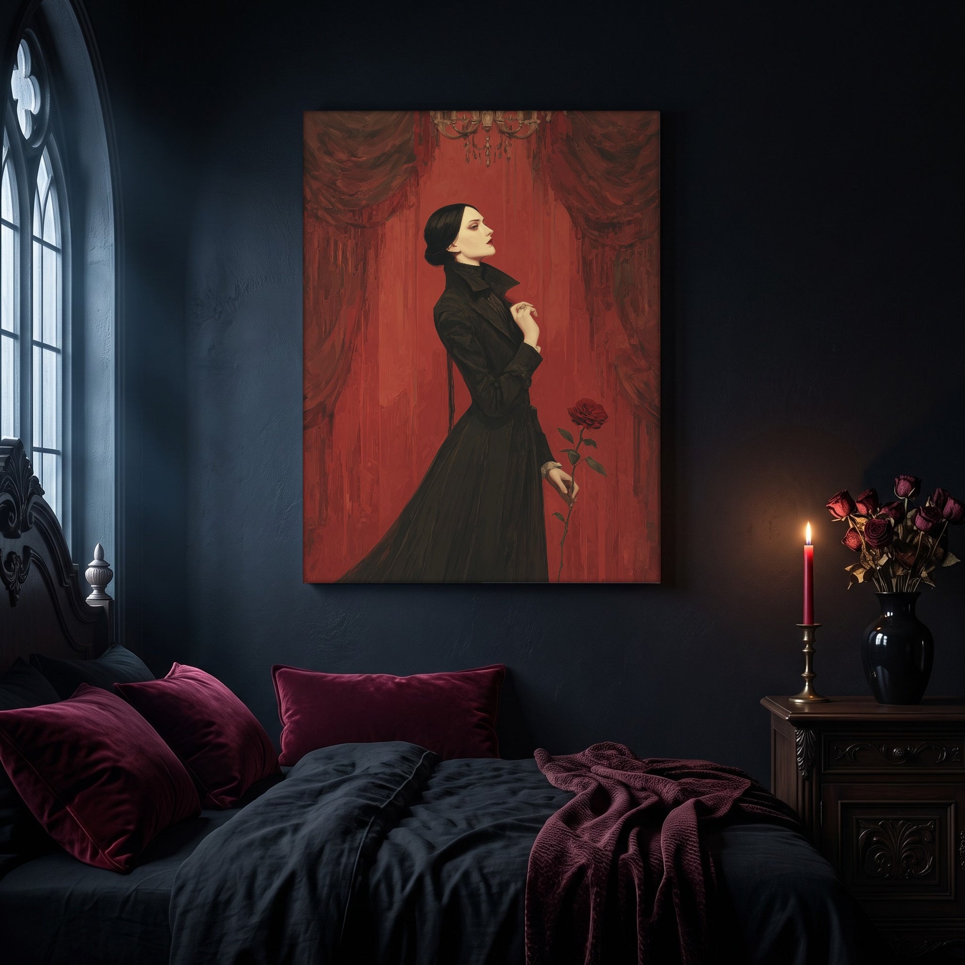 The Countess portrait canvas hanging on a dark navy wall in a gothic bedroom, above a bed with burgundy velvet pillows and charcoal bedding, beside an arched leaded window and a wooden nightstand holding a lit red taper candle in a brass holder and a black vase of dried roses.