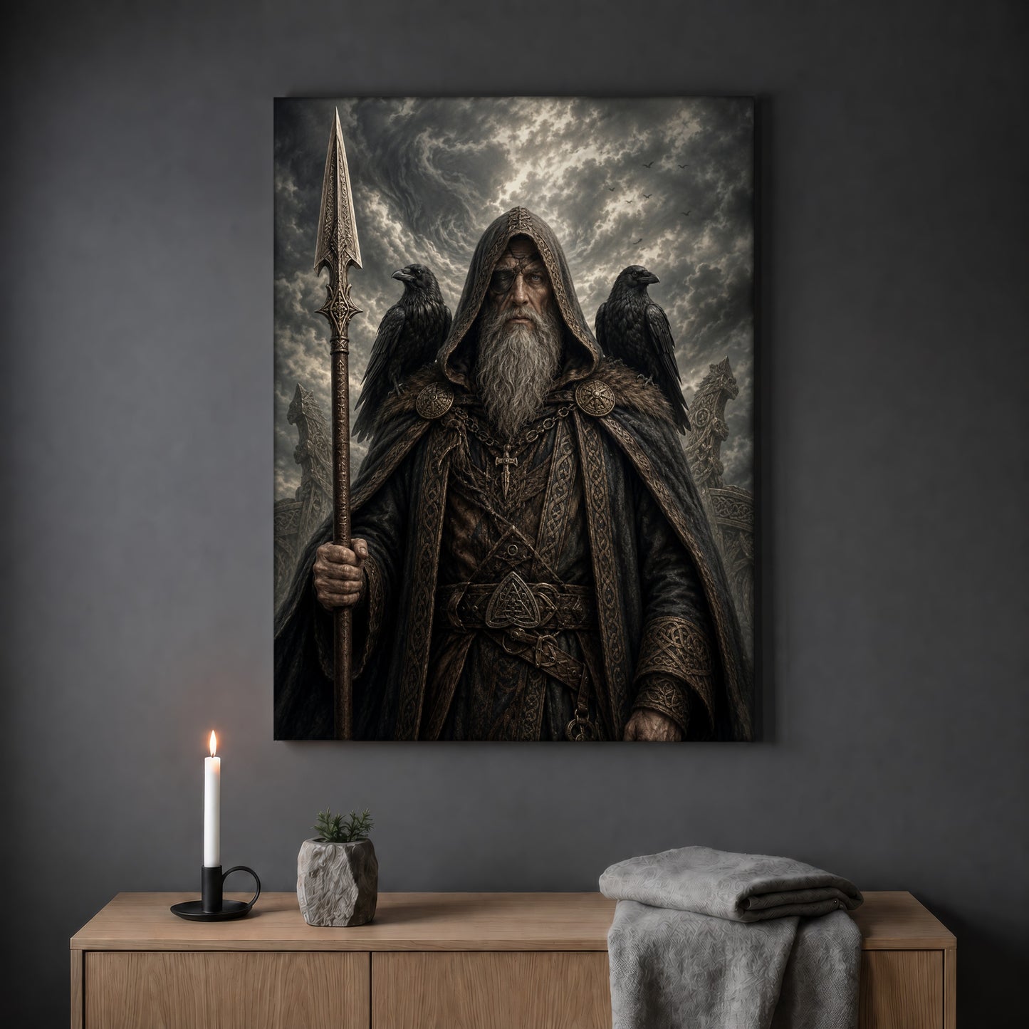 Gungnir spear print hanging on a plain grey wall above a light oak sideboard, styled with a lit white taper candle in a black holder, a small stone pot of greenery and a folded grey throw.