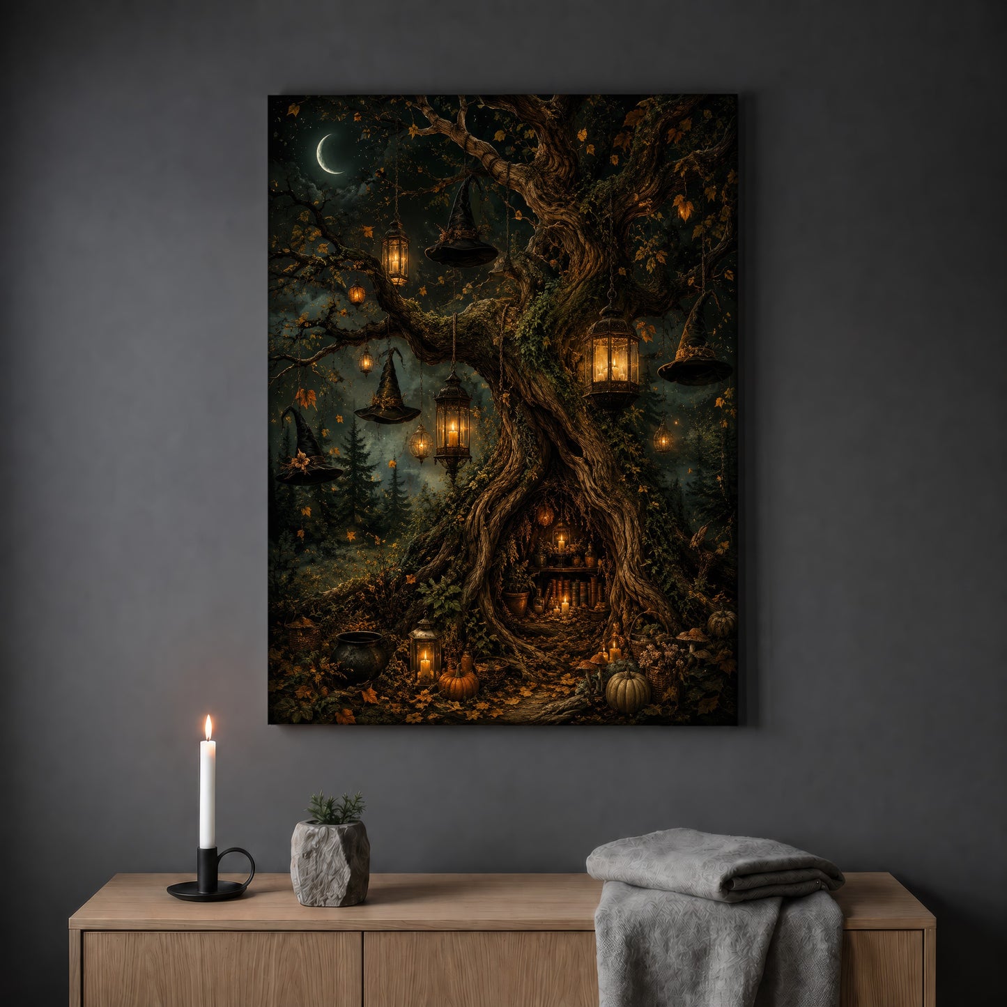 Ember Hollow forest print hanging on a plain grey wall above a light oak sideboard, styled with a lit white taper candle in a black holder, a small stone pot of greenery and a folded grey throw.
