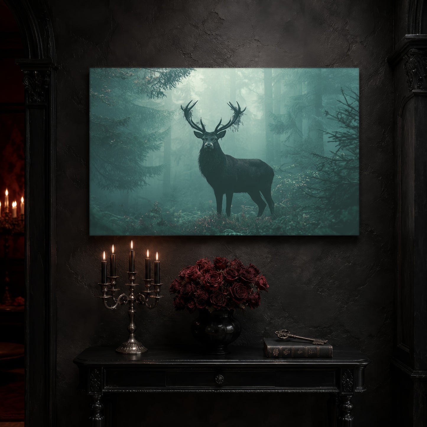 The Green Chapel forest canvas on a near-black wall above a carved black console table, with a five-arm silver candelabra of lit black tapers, a black vase of deep red roses, and an antique key resting on a leather-bound book.