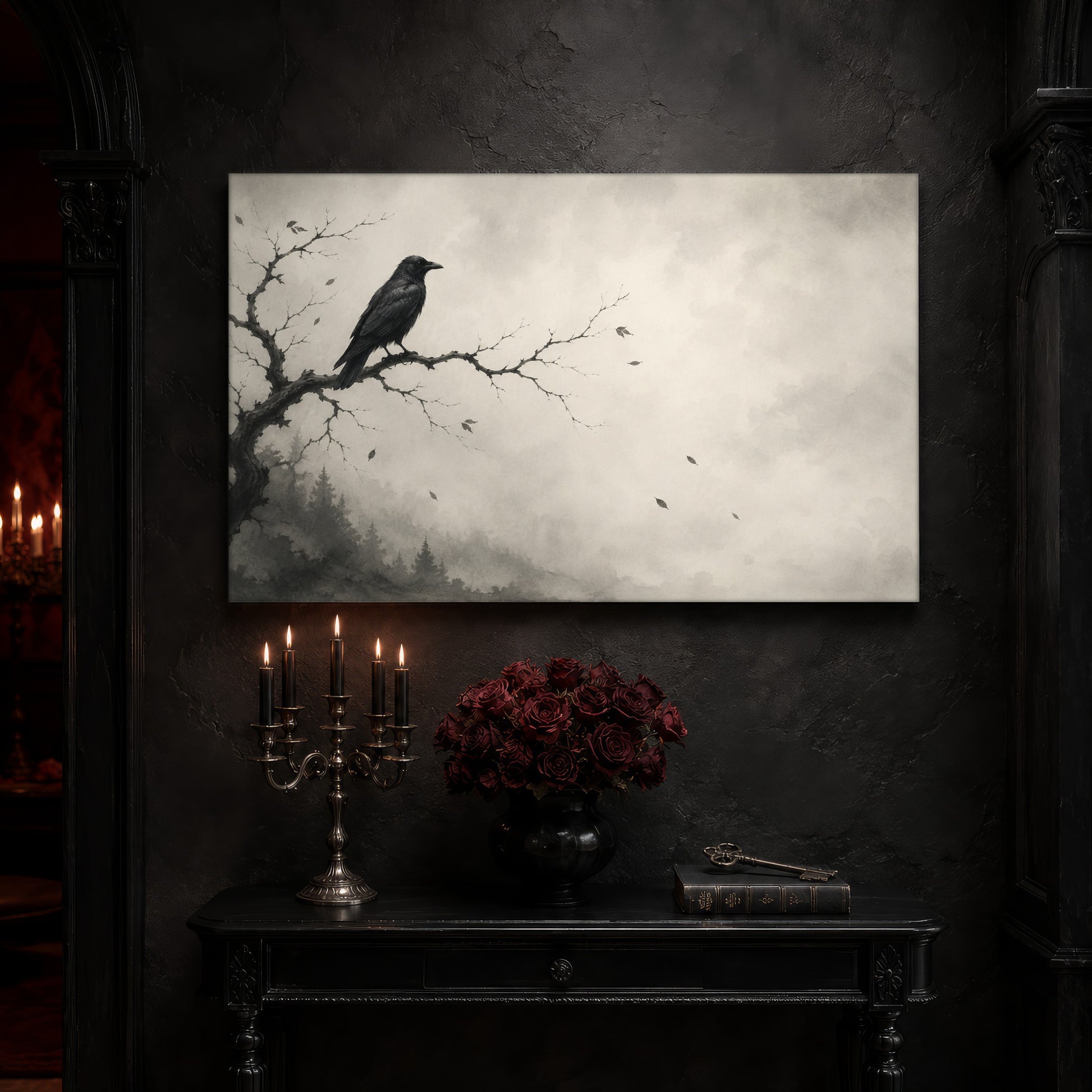 Hollow Morning foggy forest canvas on a near-black wall above a carved black console table, with a five-arm silver candelabra of lit black tapers, a black vase of deep red roses, and an antique key resting on a leather-bound book.
