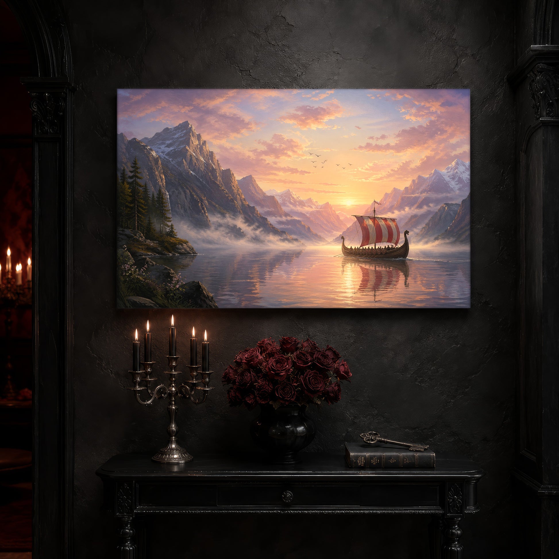 The Longship at Dawn canvas on a near-black wall above a carved black console table, with a five-arm silver candelabra of lit black tapers, a black vase of deep red roses, and an antique key resting on a leather-bound book.
