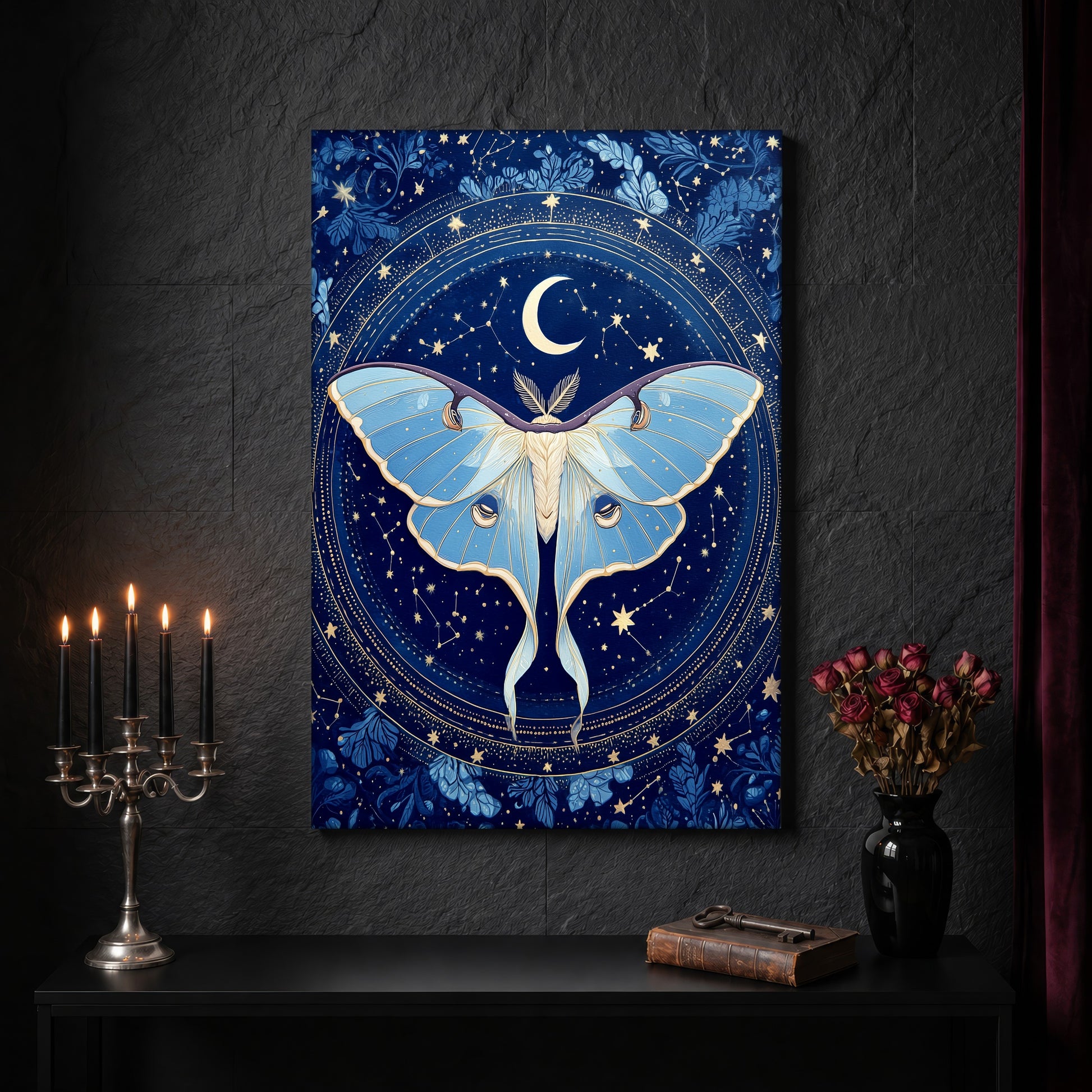 The Blue Hour celestial canvas on a dark slate stone wall above a black console table, with a five-arm silver candelabra of lit black tapers, an antique iron key resting on a worn leather book, and a black vase of dried roses beside a burgundy velvet curtain.