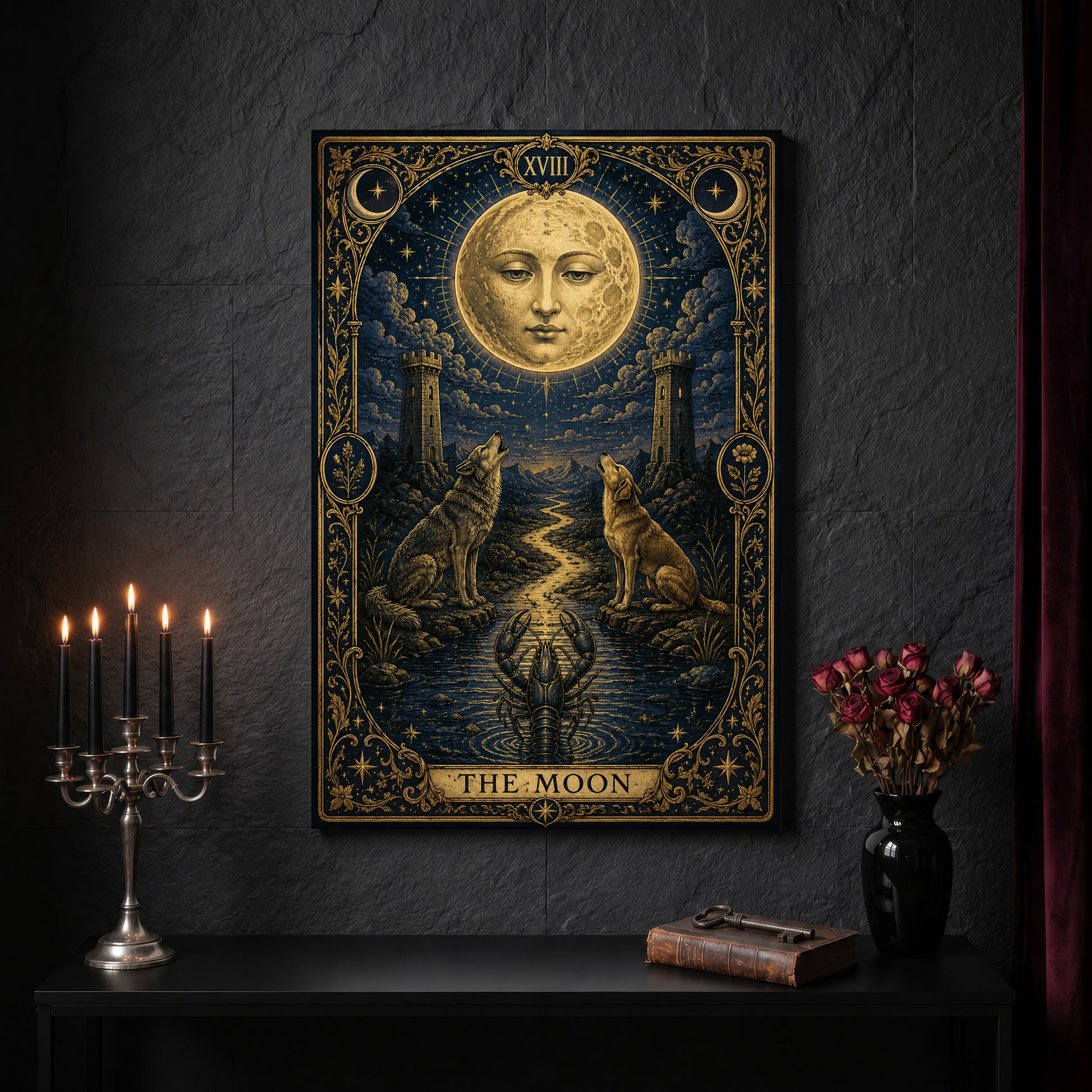 La Lune gilded tarot canvas on a dark slate stone wall above a black console table, with a five-arm silver candelabra of lit black tapers, an antique iron key resting on a worn leather book, and a black vase of dried roses beside a burgundy velvet curtain.
