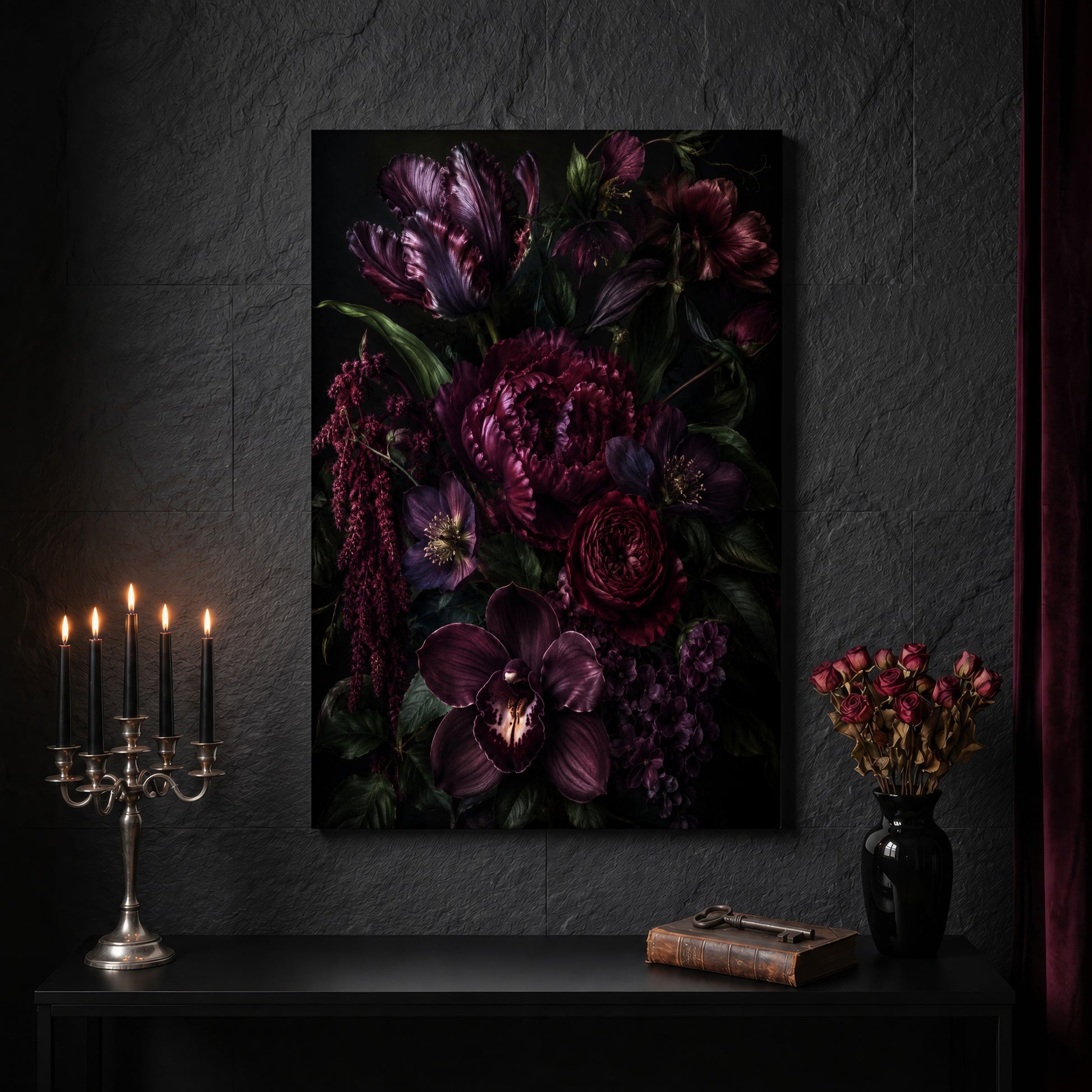 Umbra floral canvas on a dark slate stone wall above a black console table, with a five-arm silver candelabra of lit black tapers, an antique iron key resting on a worn leather book, and a black vase of dried roses beside a burgundy velvet curtain.