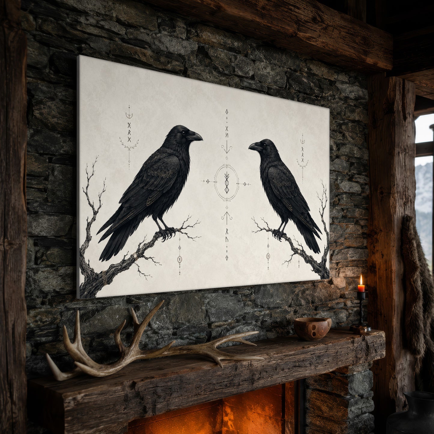 Huginn & Muninn wide canvas hanging on a rough stone chimney breast above a rustic timber mantel, with large shed antlers, a carved wooden bowl and a lit red candle along the beam, firelight glowing from the hearth below and a mountain window to the right.