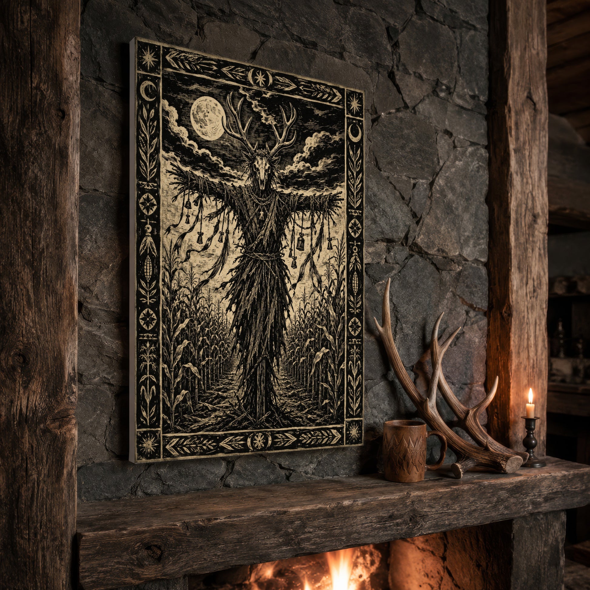 The Corn Sentinel print propped at an angle on a rustic stone fireplace mantel framed by timber beams, beside a pair of shed antlers, a carved wooden mug and a lit candle, with firelight glowing from the hearth below.