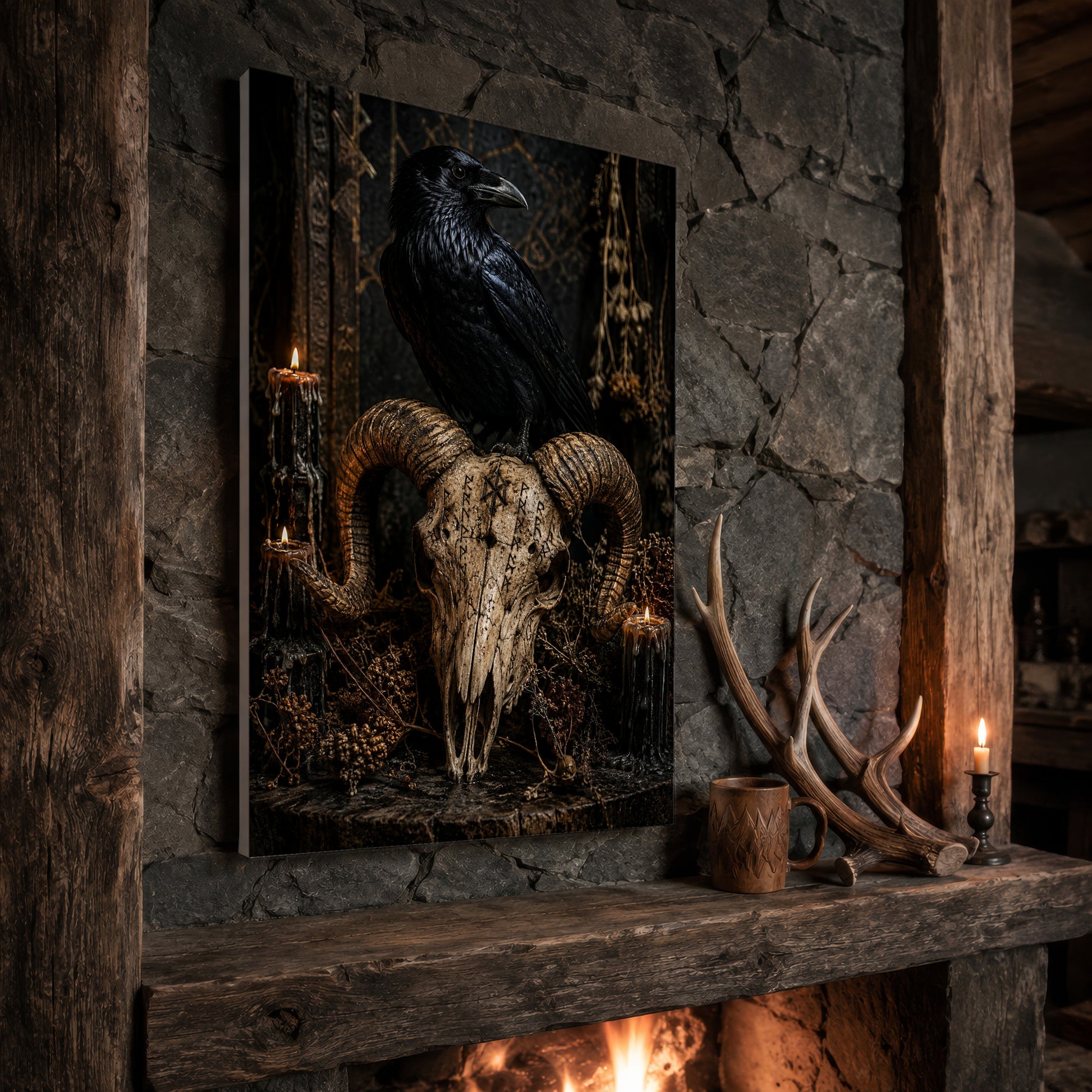 Valravn skull print propped at an angle on a rustic stone fireplace mantel framed by timber beams, beside shed antlers, a carved wooden mug and a lit candle, with firelight glowing from the hearth below.