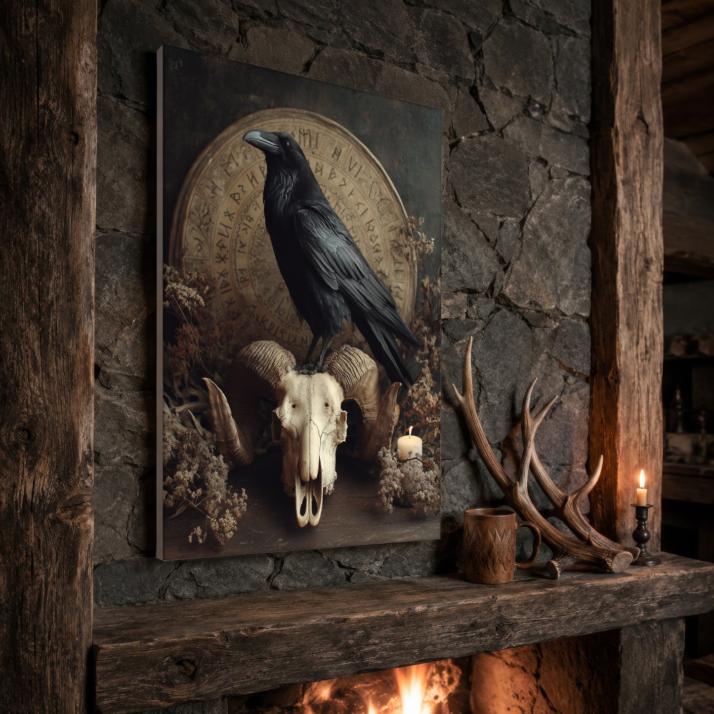 Hrafn raven print propped at an angle on a rustic stone fireplace mantel framed by timber beams, beside shed antlers, a carved wooden mug and a lit candle, with firelight glowing from the hearth below.
