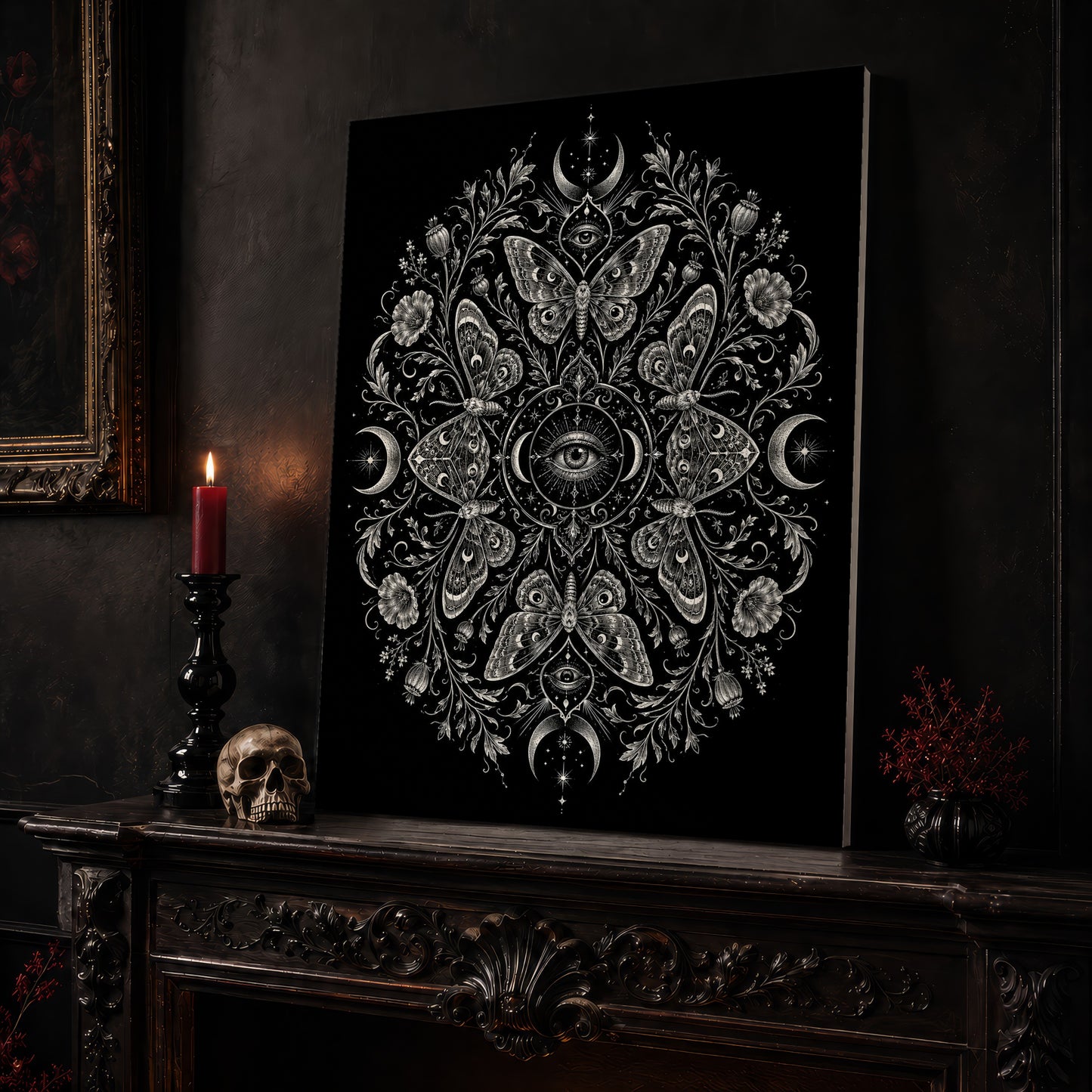 Argus eye mandala canvas leaning on a dark carved mantel beside a lit dark red taper in a black candlestick, a bone-coloured skull, and a small black vase of red berry sprigs, with a gilt-framed painting on the wall alongside.