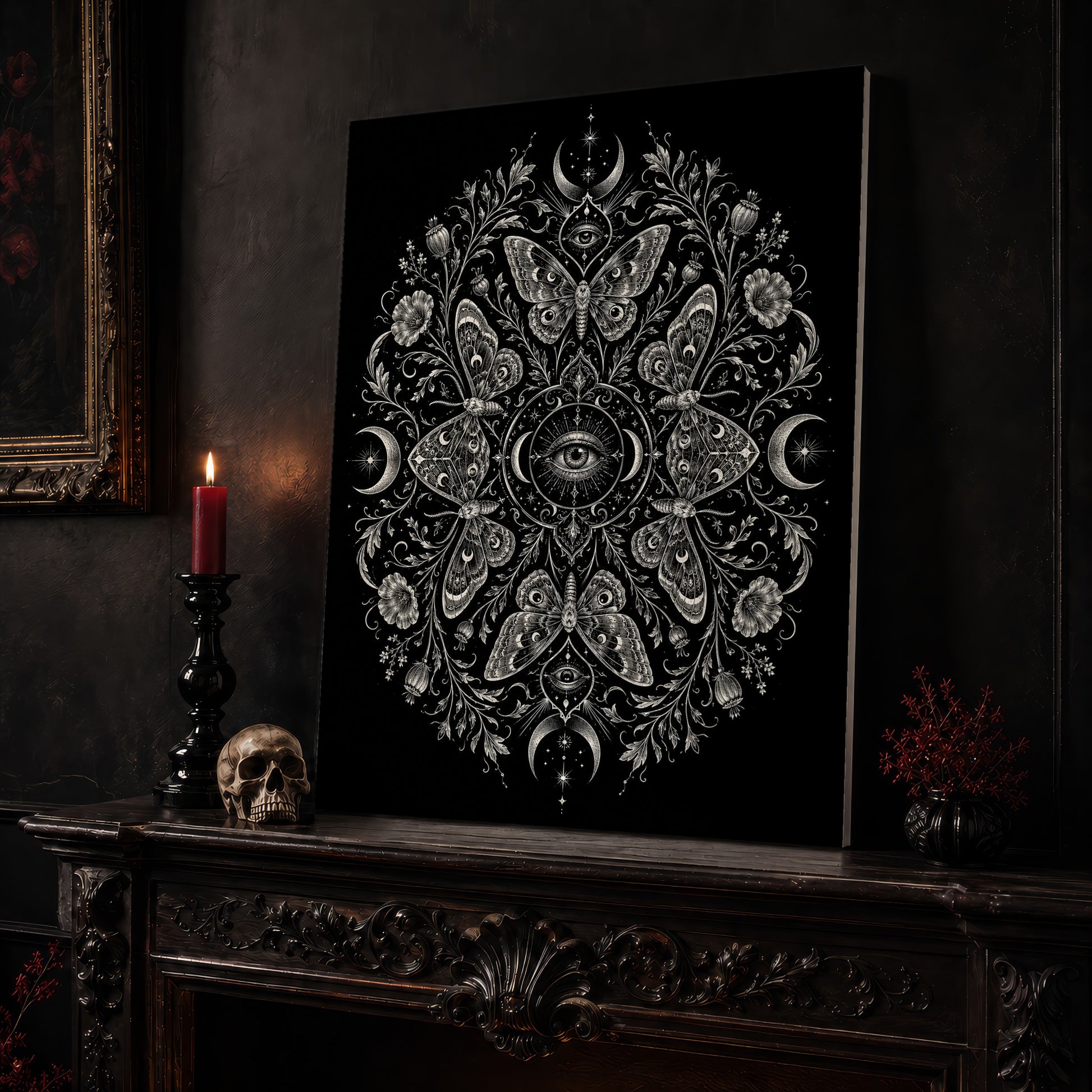 Argus eye mandala canvas leaning on a dark carved mantel beside a lit dark red taper in a black candlestick, a bone-coloured skull, and a small black vase of red berry sprigs, with a gilt-framed painting on the wall alongside.