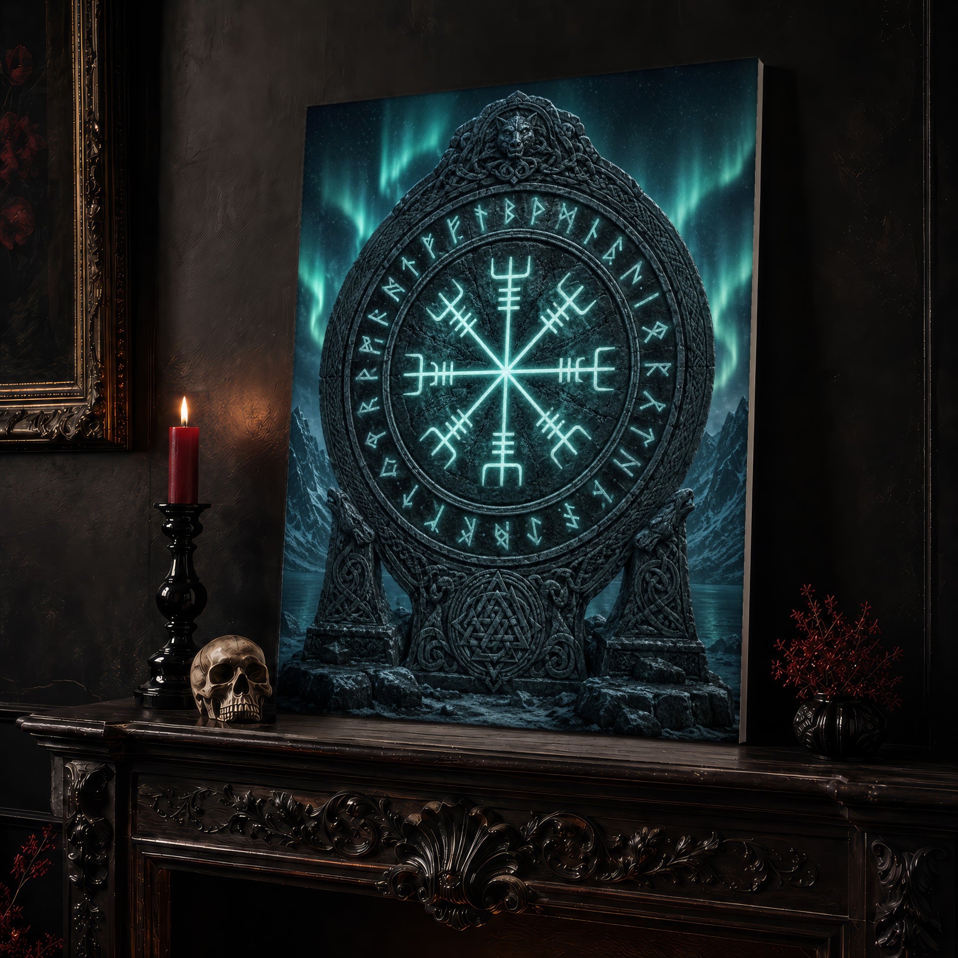 Vegvísir stave canvas leaning on a dark carved mantel beside a lit dark red taper in a black candlestick, a bone-coloured skull, and a small black vase of red berry sprigs, with a gilt-framed painting on the wall alongside.