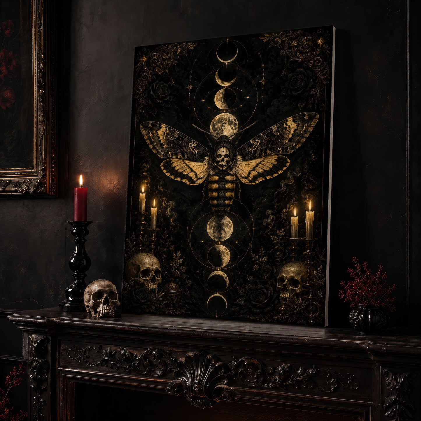Acherontia moth canvas leaning on a dark carved mantel beside a lit dark red taper in a black candlestick, a bone-coloured skull, and a small black vase of red berry sprigs, with a gilt-framed painting on the wall alongside.