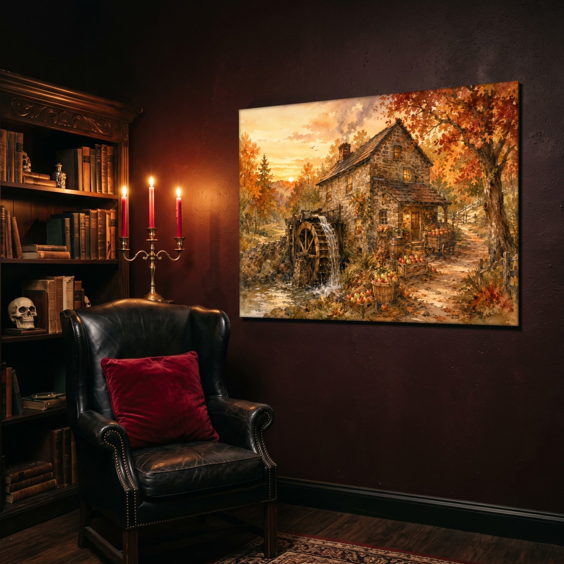 Millpond Gold landscape canvas hanging on a deep oxblood wall in a reading nook, above a black leather wingback chair with a red velvet cushion, beside a carved bookcase of antique books, a brass candelabra of lit red tapers and a human skull on the shelf.