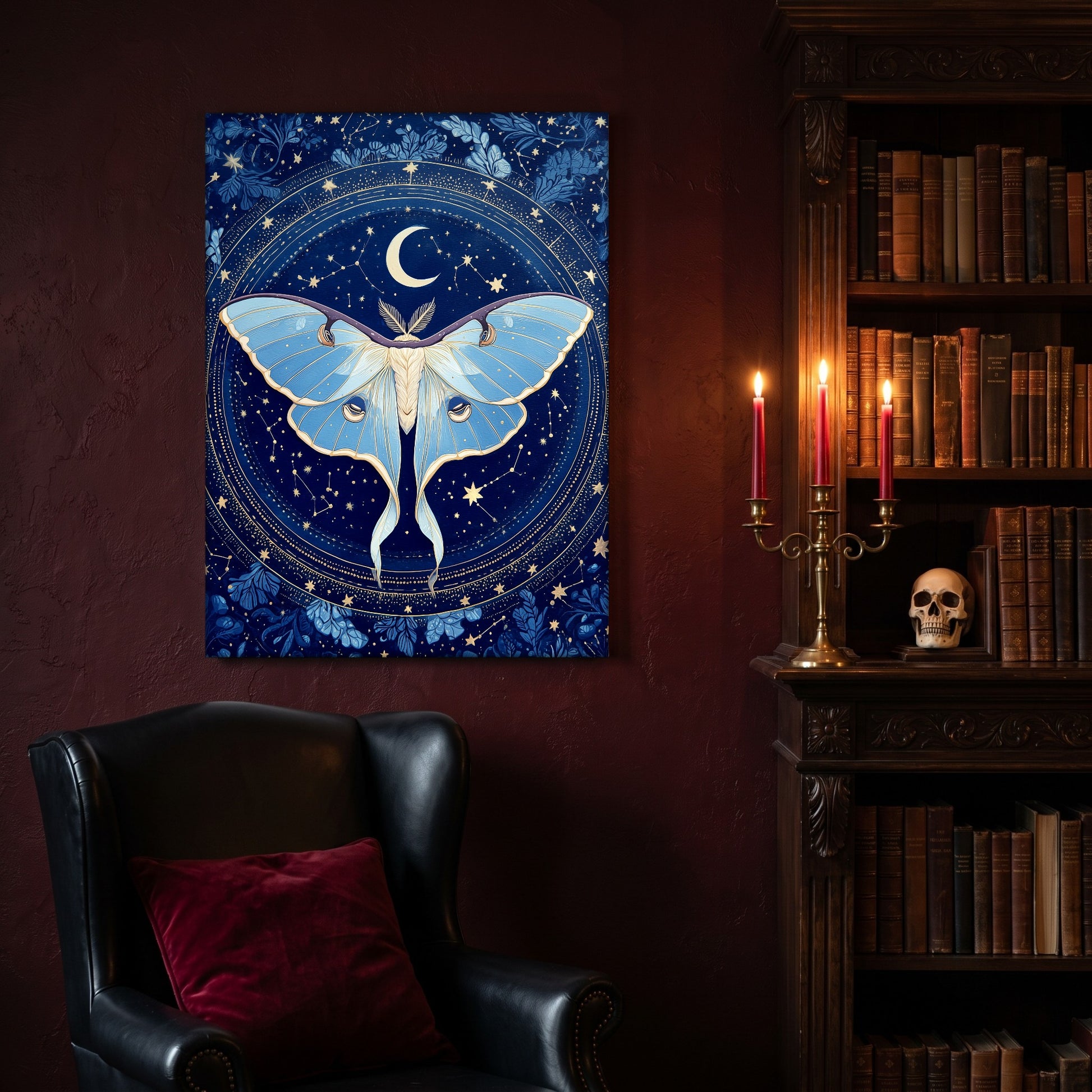 The Blue Hour astrolabe canvas hanging on a deep oxblood wall in a reading nook, above a black leather wingback chair with a red velvet cushion, beside a carved bookcase of antique books, a brass candelabra of lit red tapers and a human skull on the shelf.