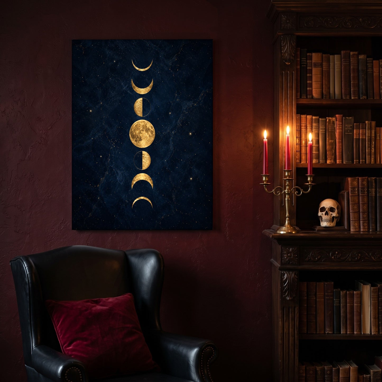 Lunarium moon phase canvas hanging on a deep oxblood wall in a reading nook, above a black leather wingback chair with a red velvet cushion, beside a carved bookcase of antique books, a brass candelabra of lit red tapers and a human skull on the shelf.