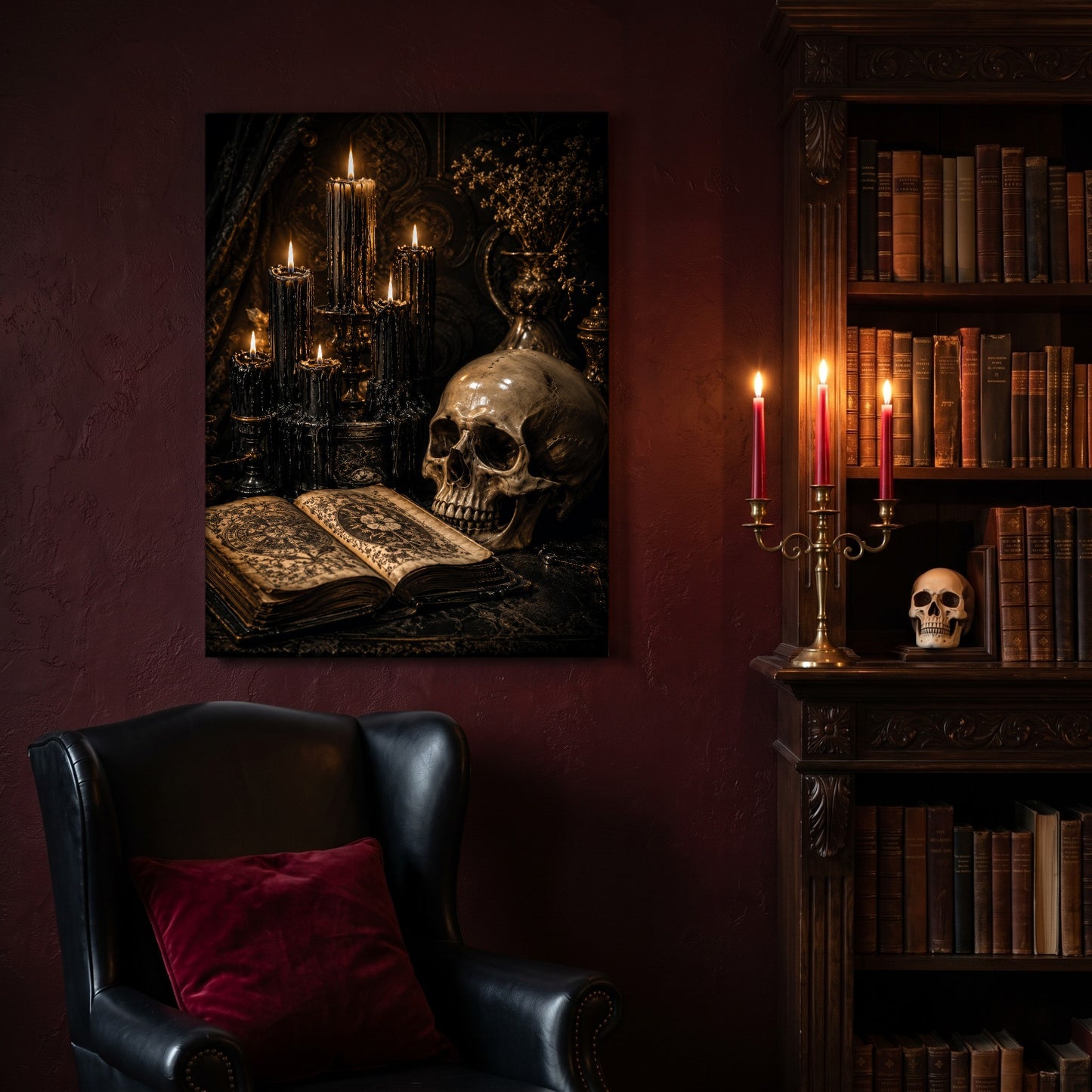 The Black Hours canvas hanging on a deep oxblood wall in a reading nook, above a black leather wingback chair with a red velvet cushion, beside a carved bookcase of antique books, a brass candelabra of lit red tapers and a human skull on the shelf.