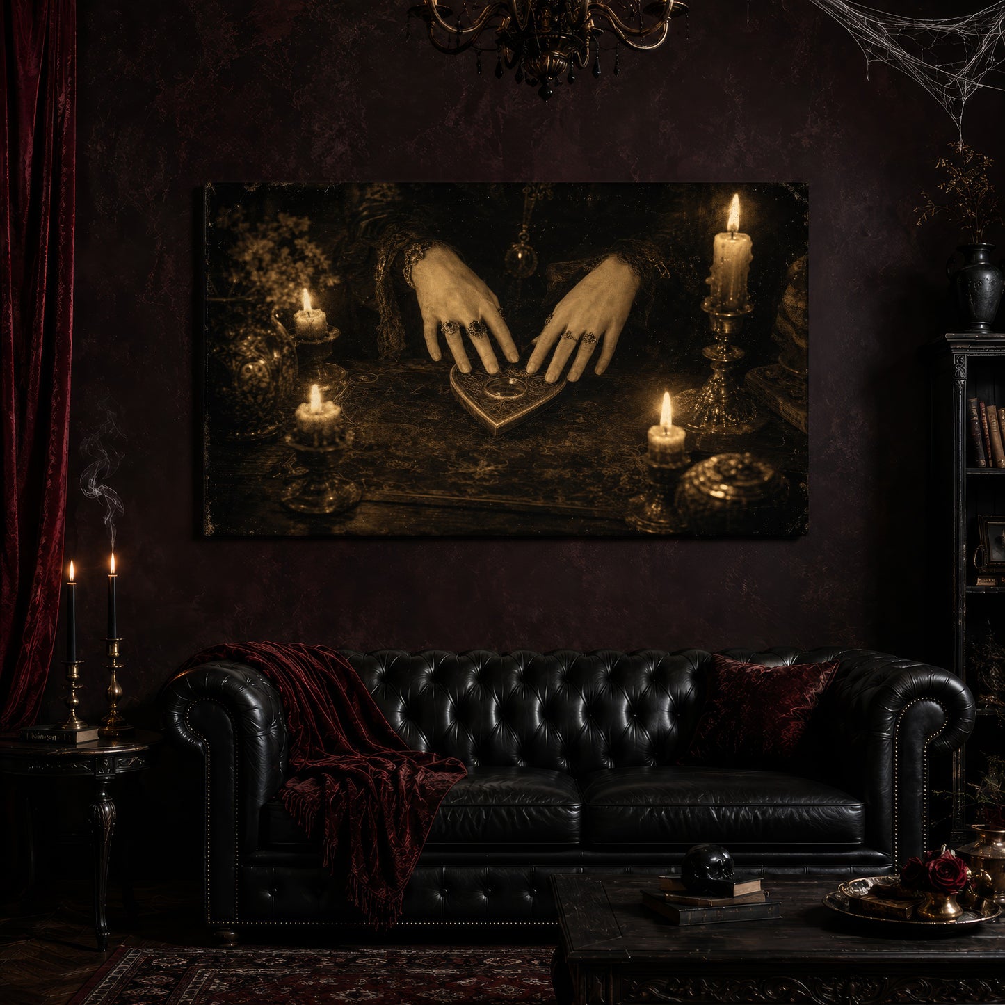 Midnight Communion canvas hanging above a black tufted Chesterfield sofa draped with a red velvet throw and pillow, in a gothic parlor with a crystal chandelier, cobwebs, a red velvet curtain, black taper candles, and a small skull resting on books at the coffee table.