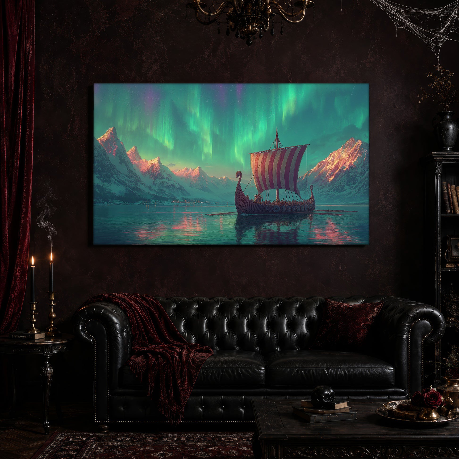 Vinland canvas hanging above a black tufted Chesterfield sofa draped with a red fringed velvet throw, in a cobwebbed oxblood parlour with a brass chandelier, lit black tapers, red velvet curtains and a patterned rug.