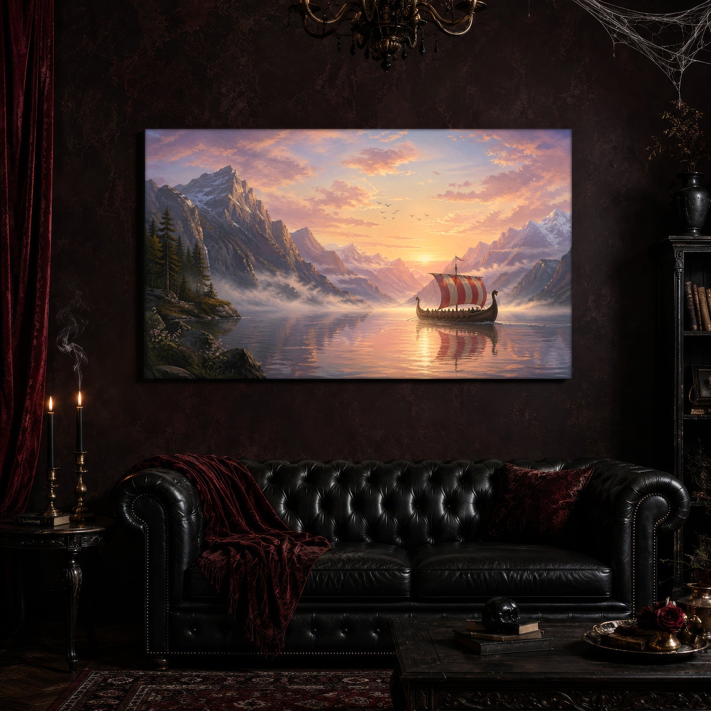 The Longship at Dawn canvas hanging above a black tufted Chesterfield sofa draped with a red fringed velvet throw, in a cobwebbed oxblood parlour with a brass chandelier, lit black tapers, red velvet curtains and a patterned rug.