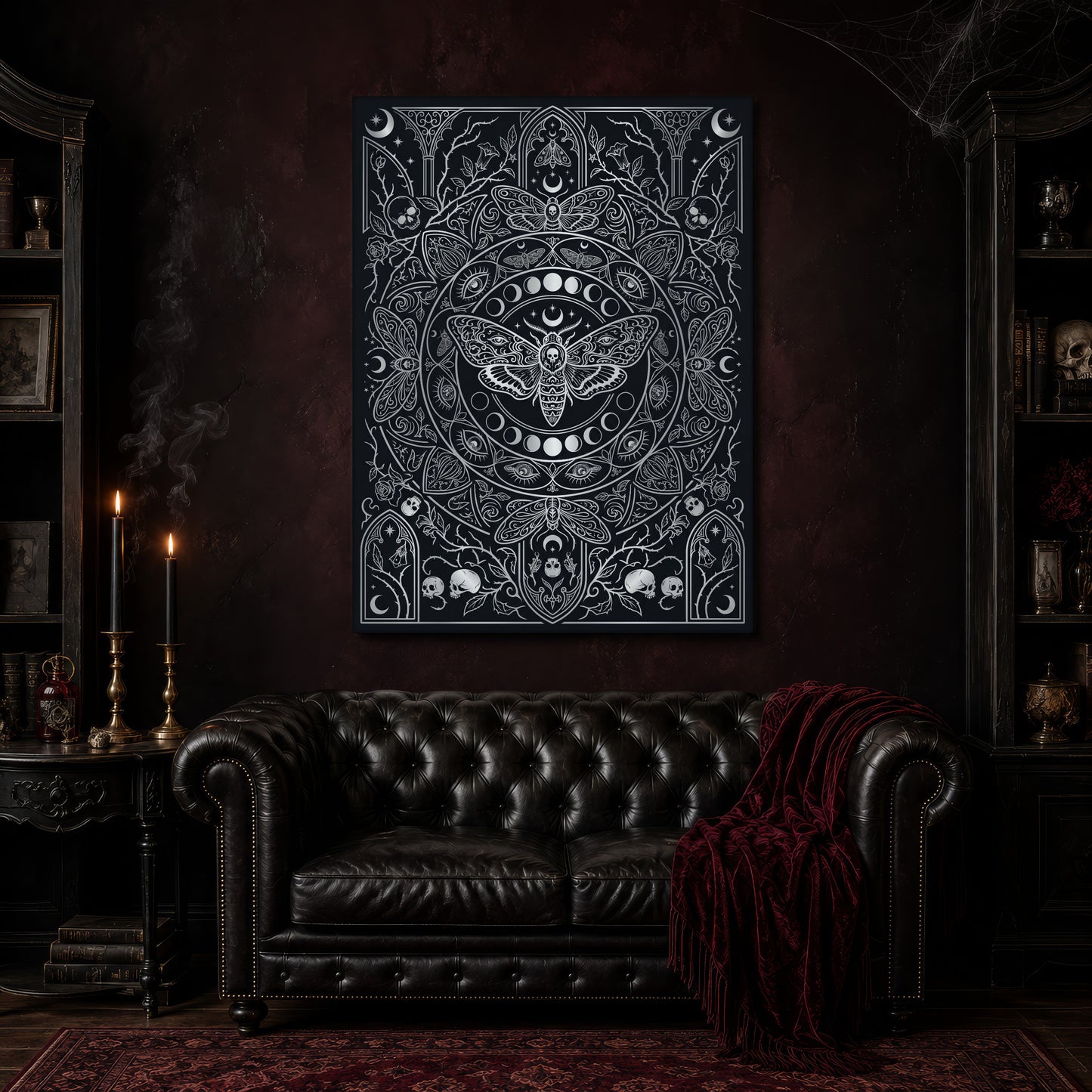 Vanitas memento mori canvas hanging above a black tufted Chesterfield sofa draped with a red fringed velvet throw, in a cobwebbed oxblood parlour with brass candlesticks, dark cabinets of books and goblets, and a patterned red rug.