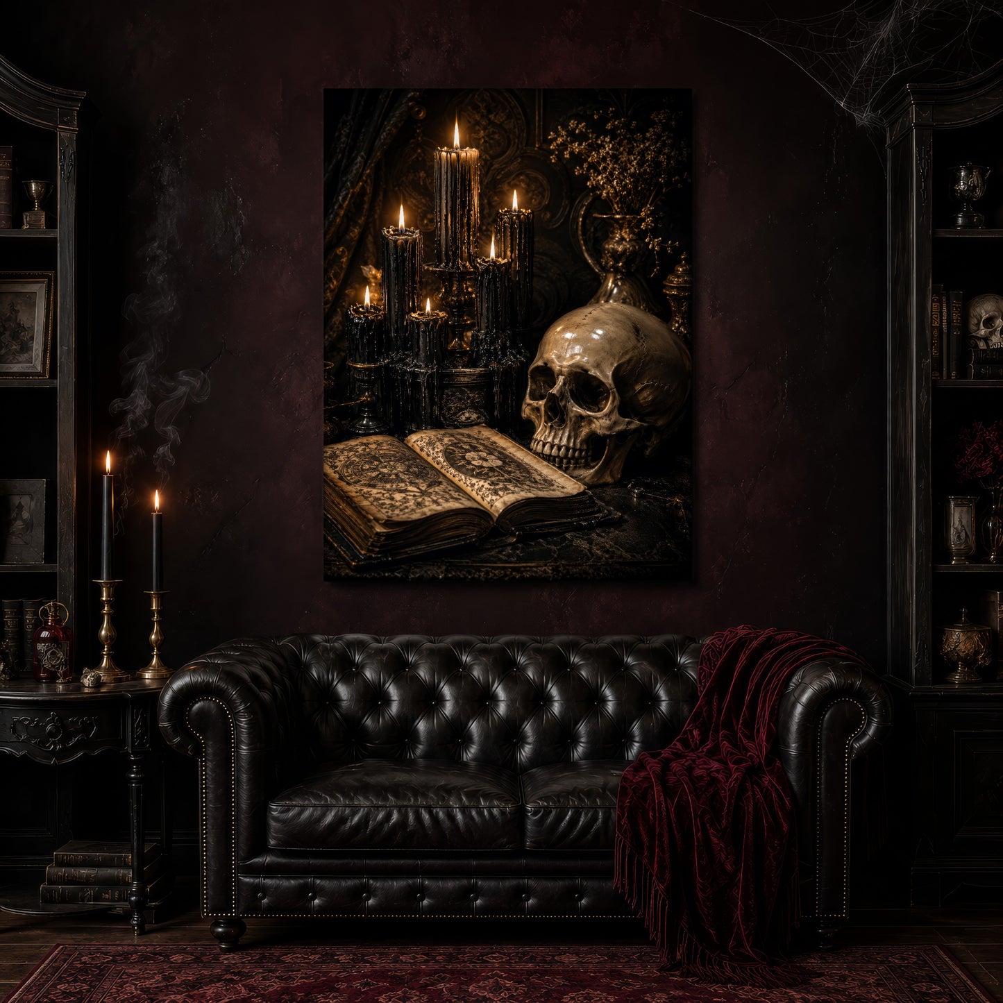 The Black Hours canvas hanging above a black tufted Chesterfield sofa draped with a red fringed velvet throw, in a cobwebbed oxblood parlour with brass candlesticks, dark cabinets of books and goblets, and a patterned red rug.