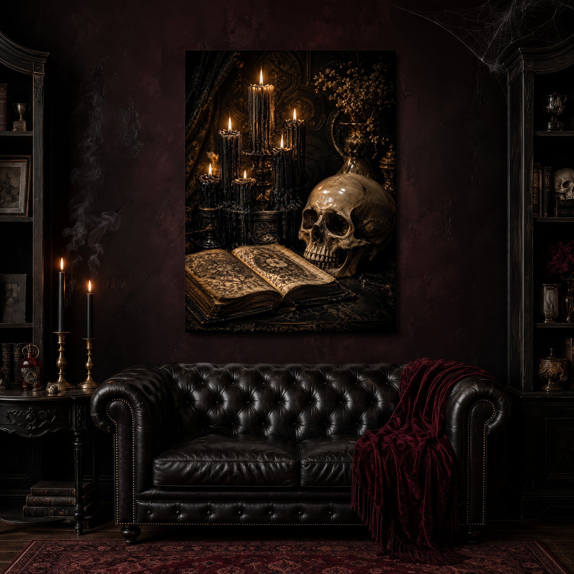 The Black Hours canvas hanging above a black tufted Chesterfield sofa draped with a red fringed velvet throw, in a cobwebbed oxblood parlour with brass candlesticks, dark cabinets of books and goblets, and a patterned red rug.
