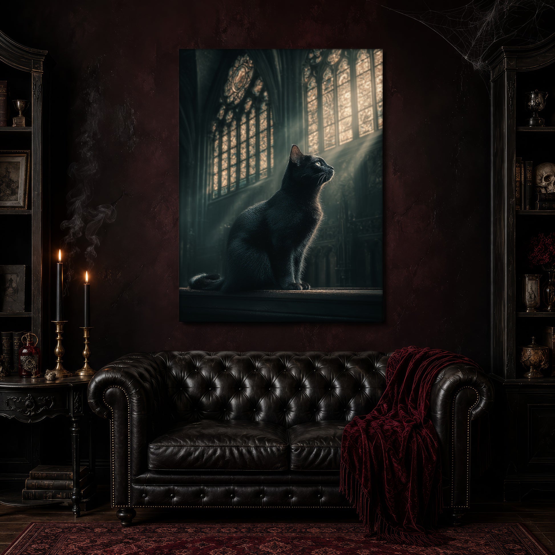 Grimalkin canvas hanging above a black tufted Chesterfield sofa draped with a red fringed velvet throw, in a cobwebbed oxblood parlour with brass candlesticks, dark cabinets of books and goblets, and a patterned red rug.