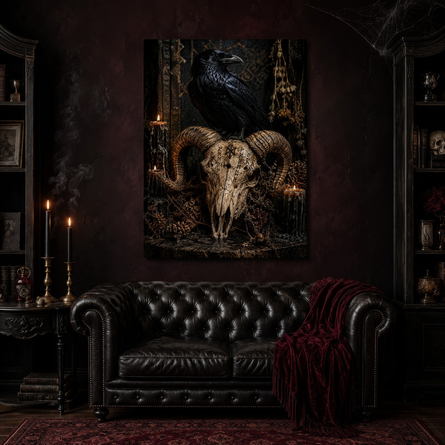 Valravn canvas hanging above a black tufted Chesterfield sofa draped with a red fringed velvet throw, in a cobwebbed oxblood parlour with brass candlesticks, dark cabinets of books and goblets, and a patterned red rug.