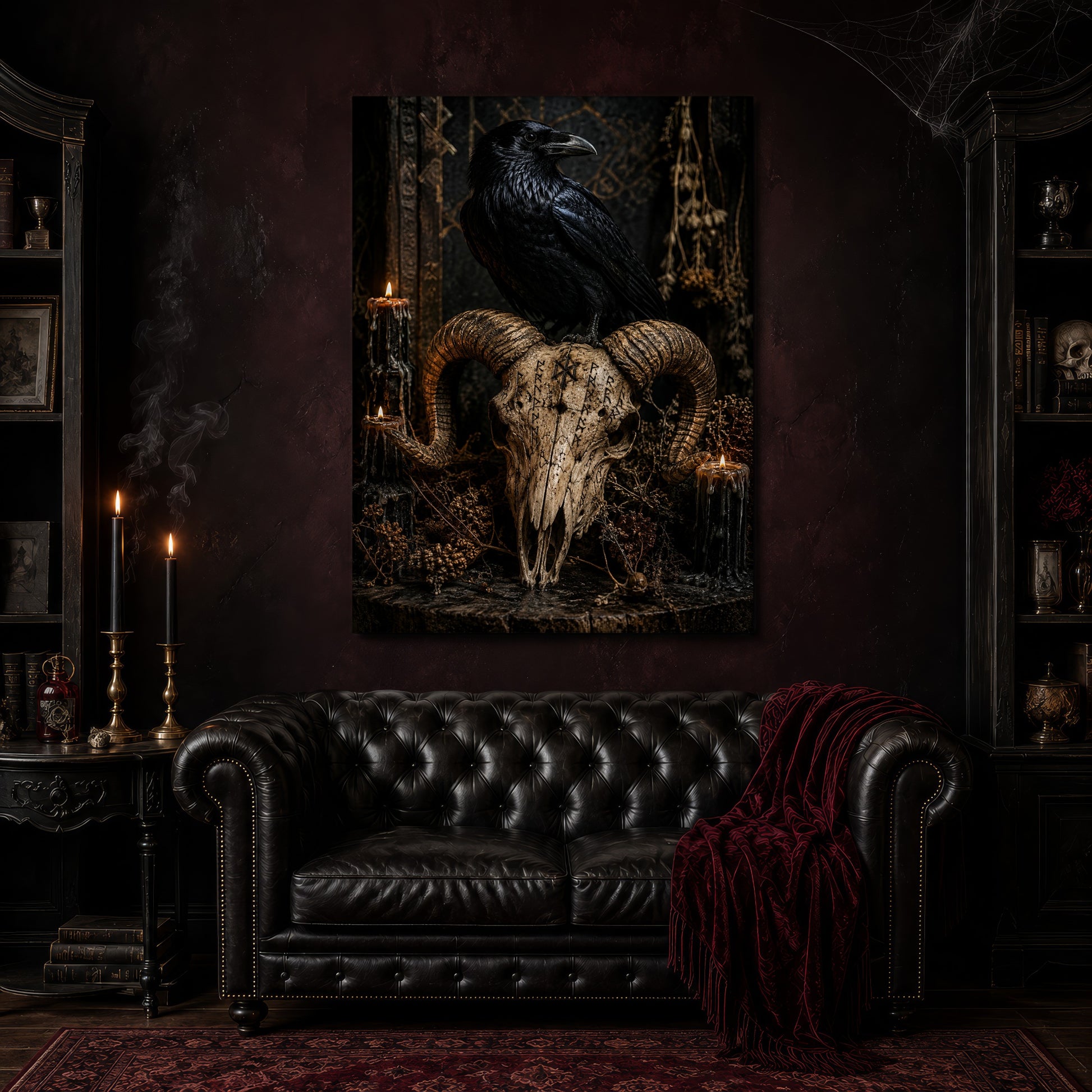 Valravn canvas hanging above a black tufted Chesterfield sofa draped with a red fringed velvet throw, in a cobwebbed oxblood parlour with brass candlesticks, dark cabinets of books and goblets, and a patterned red rug.